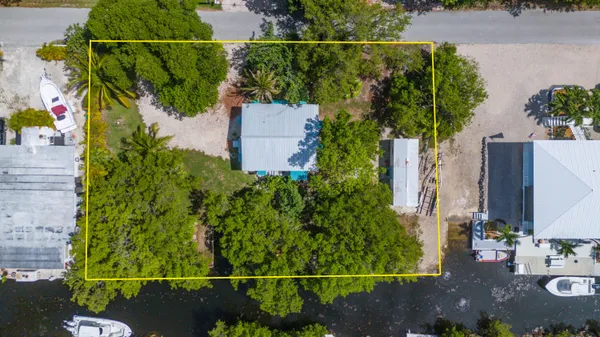 an aerial view of a house with a yard and garden