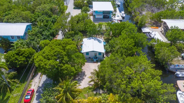 a view of a house with a yard and tree s