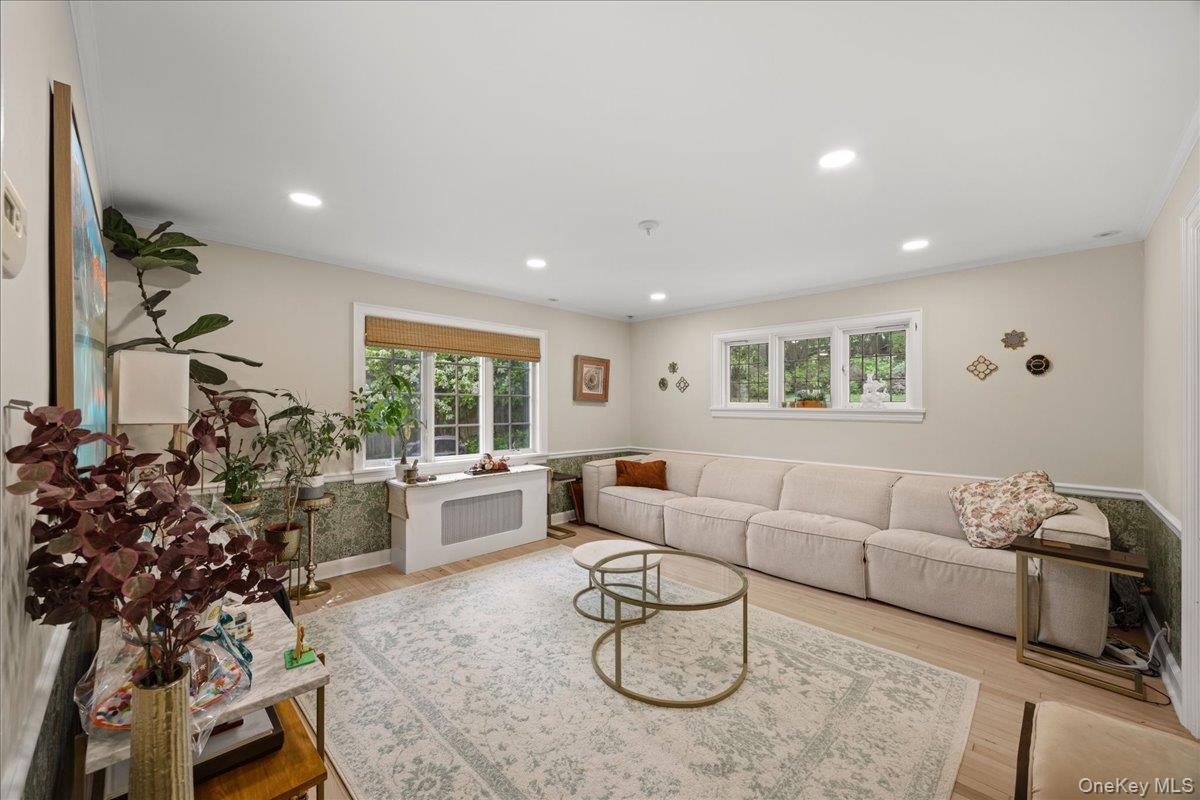 311 Lyncroft Road New Rochelle, NY 10804 - Photo 9 of 39 a living room with furniture potted plant and a large window