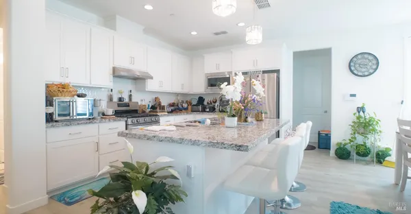 a kitchen with kitchen island granite countertop lots of counter top space and windows