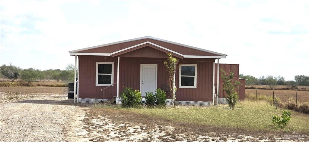 189 Midway Road Rio Grande City, TX 78582 - Photo 2 of 20 Brown siding exterior with a white front door and white trim windows