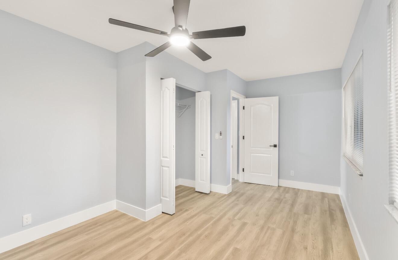 6717 Northwest 60th Street Tamarac, FL 33321 - Photo 11 of 26 an empty room with wooden floor and ceiling fan