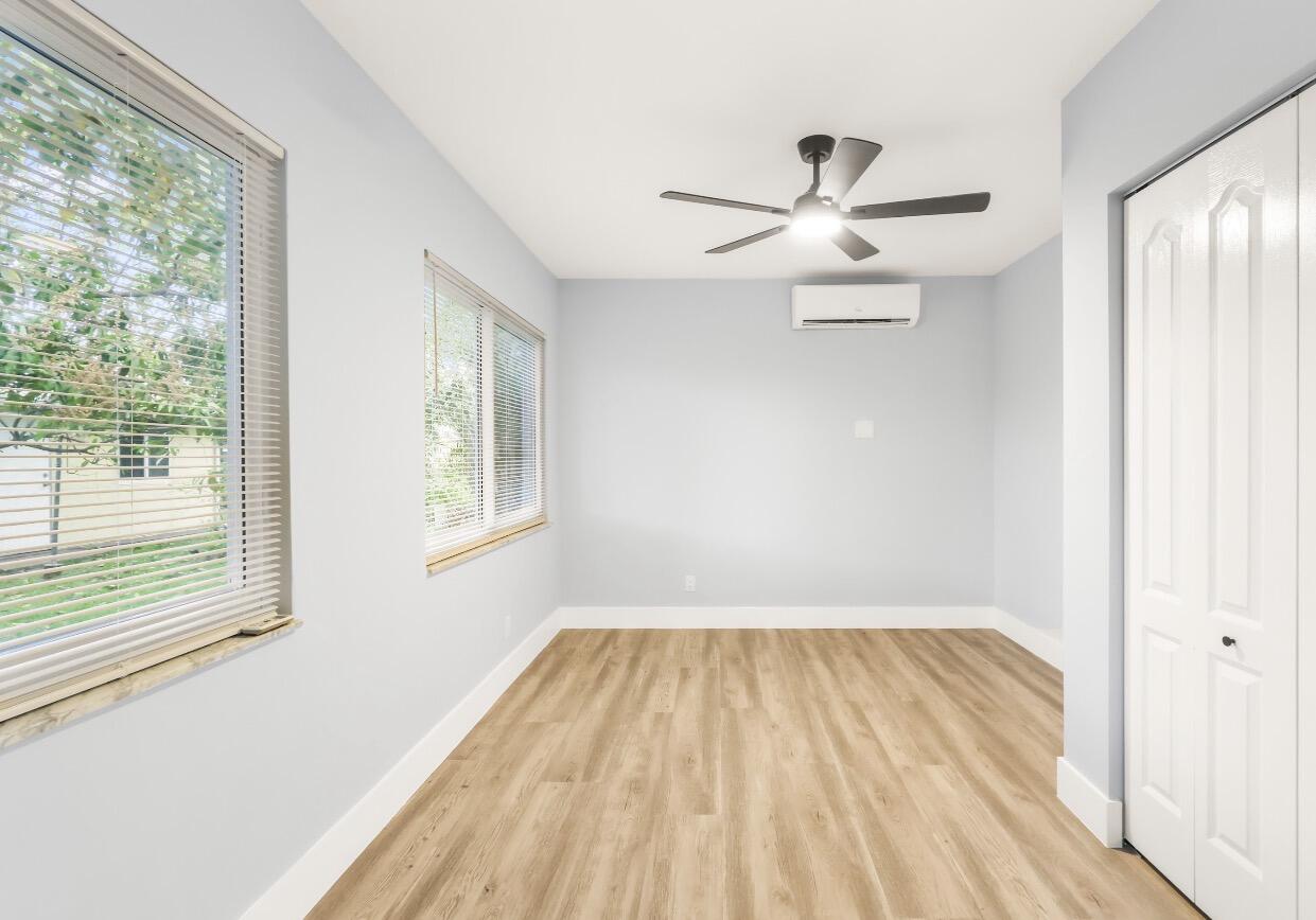 6717 Northwest 60th Street Tamarac, FL 33321 - Photo 12 of 26 a view of empty room with wooden floor and fan
