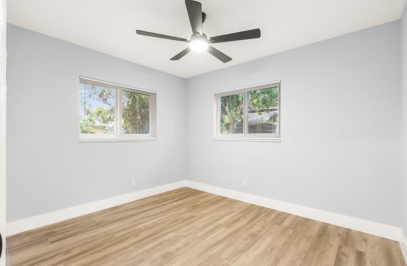 6717 Northwest 60th Street Tamarac, FL 33321 - Photo 13 of 26 a view of room with window and wooden floor
