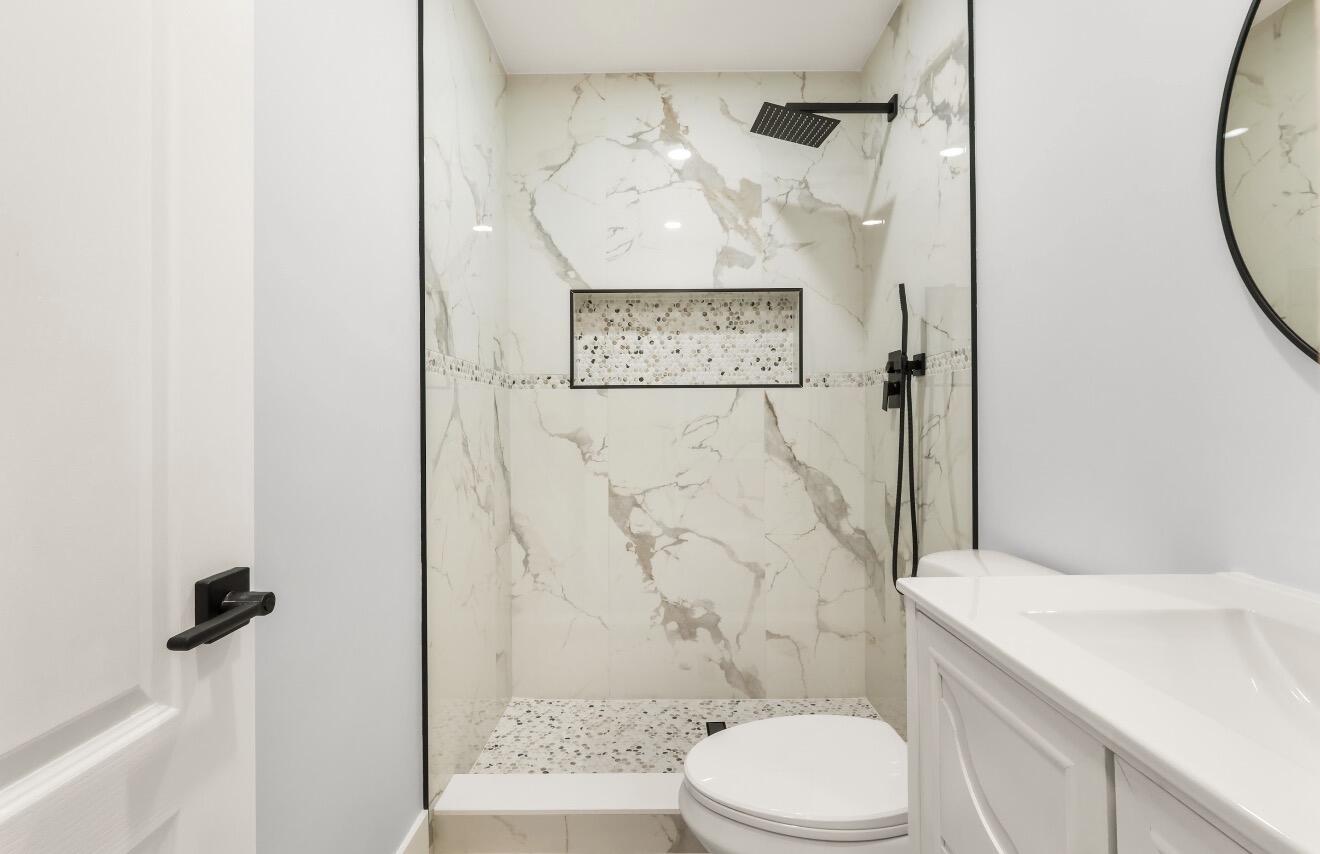 6717 Northwest 60th Street Tamarac, FL 33321 - Photo 14 of 26 a bathroom with a toilet sink and shower