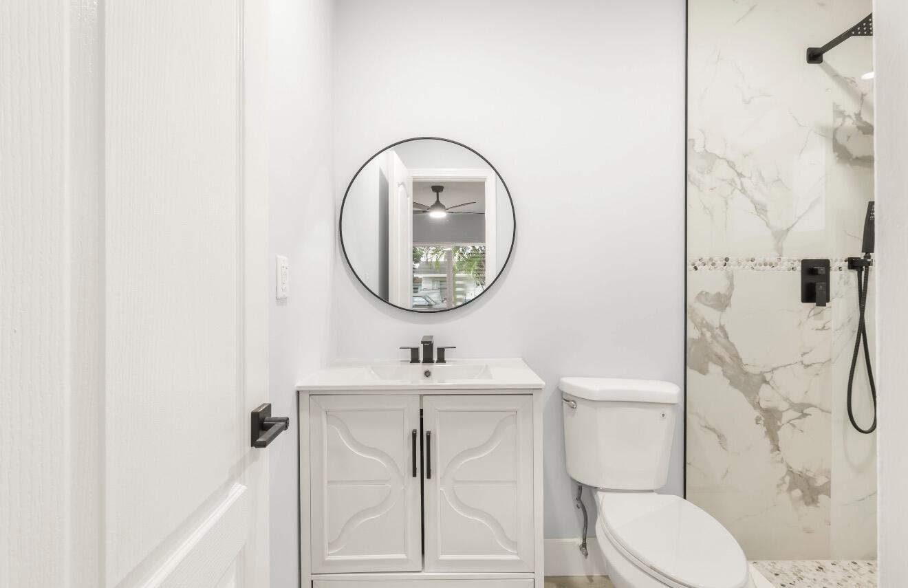 6717 Northwest 60th Street Tamarac, FL 33321 - Photo 15 of 26 a bathroom with a toilet sink vanity tub and shower