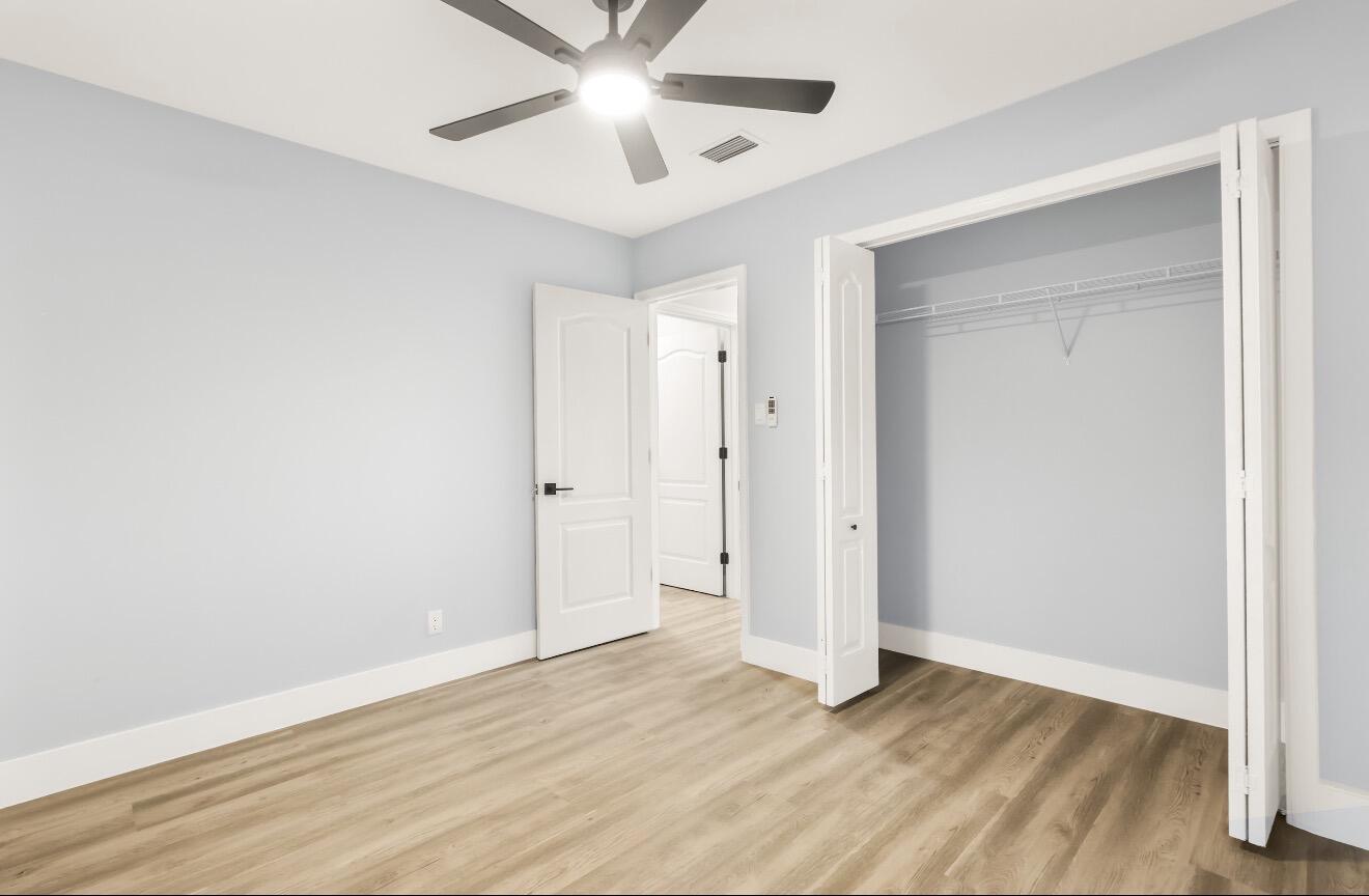 6717 Northwest 60th Street Tamarac, FL 33321 - Photo 17 of 26 an empty room with wooden floor and ceiling fan