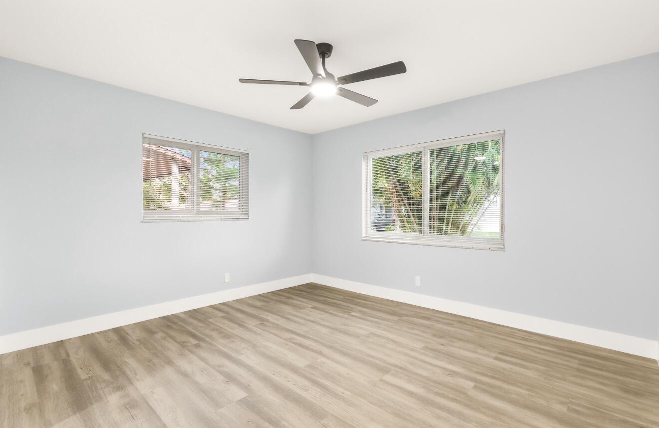 6717 Northwest 60th Street Tamarac, FL 33321 - Photo 18 of 26 a view of empty room with wooden floor and fan