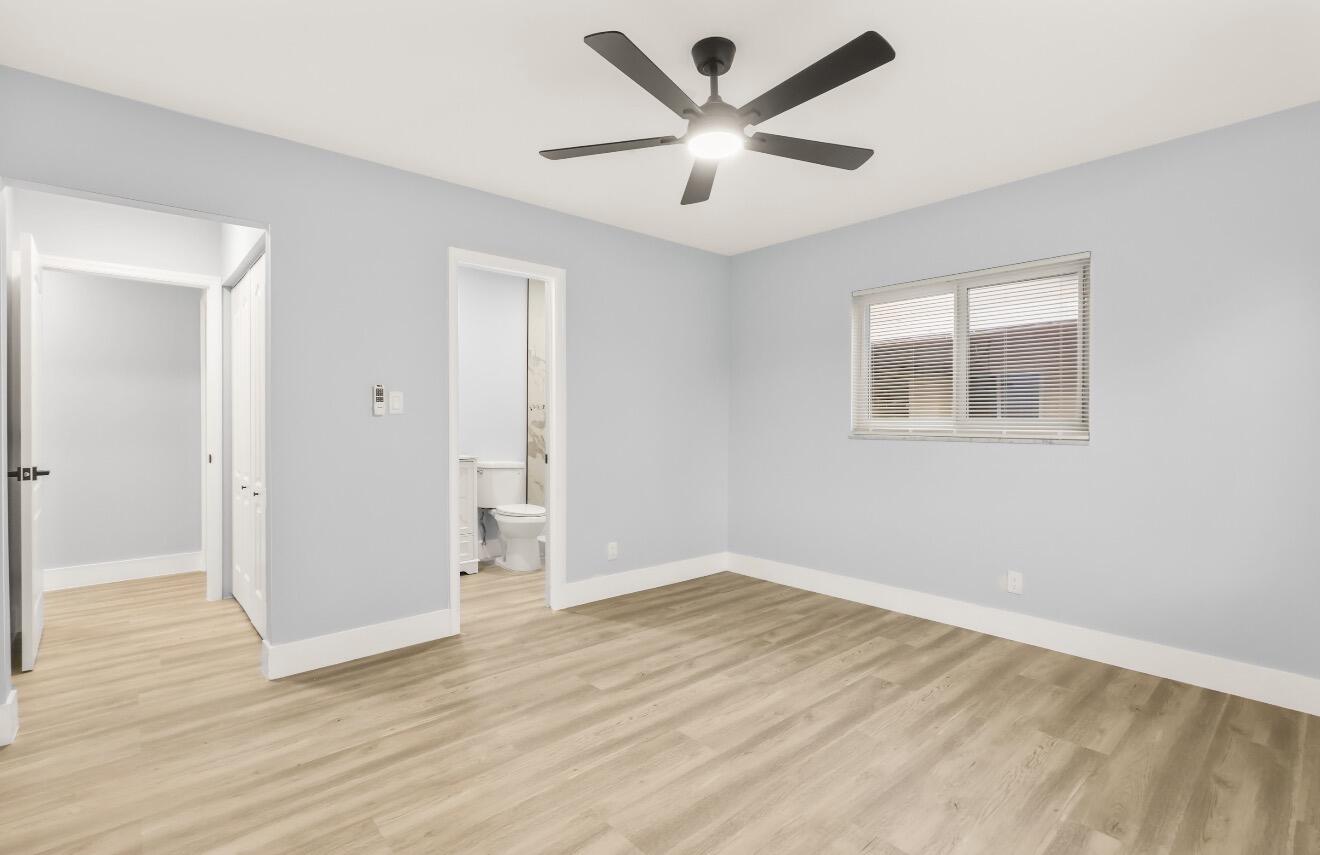6717 Northwest 60th Street Tamarac, FL 33321 - Photo 19 of 26 an empty room with wooden floor and windows