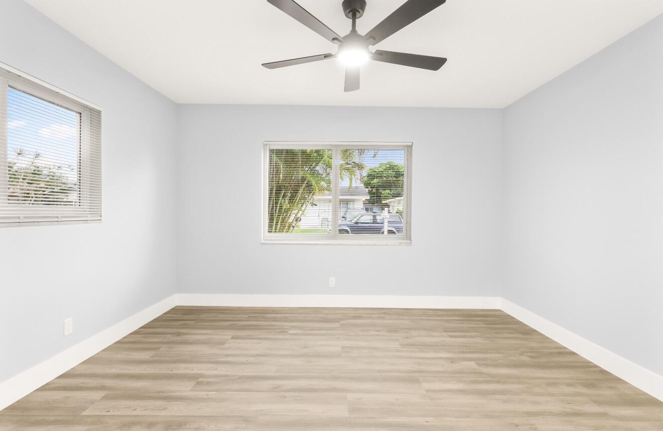 6717 Northwest 60th Street Tamarac, FL 33321 - Photo 21 of 26 a view of an empty room with wooden floor and a window