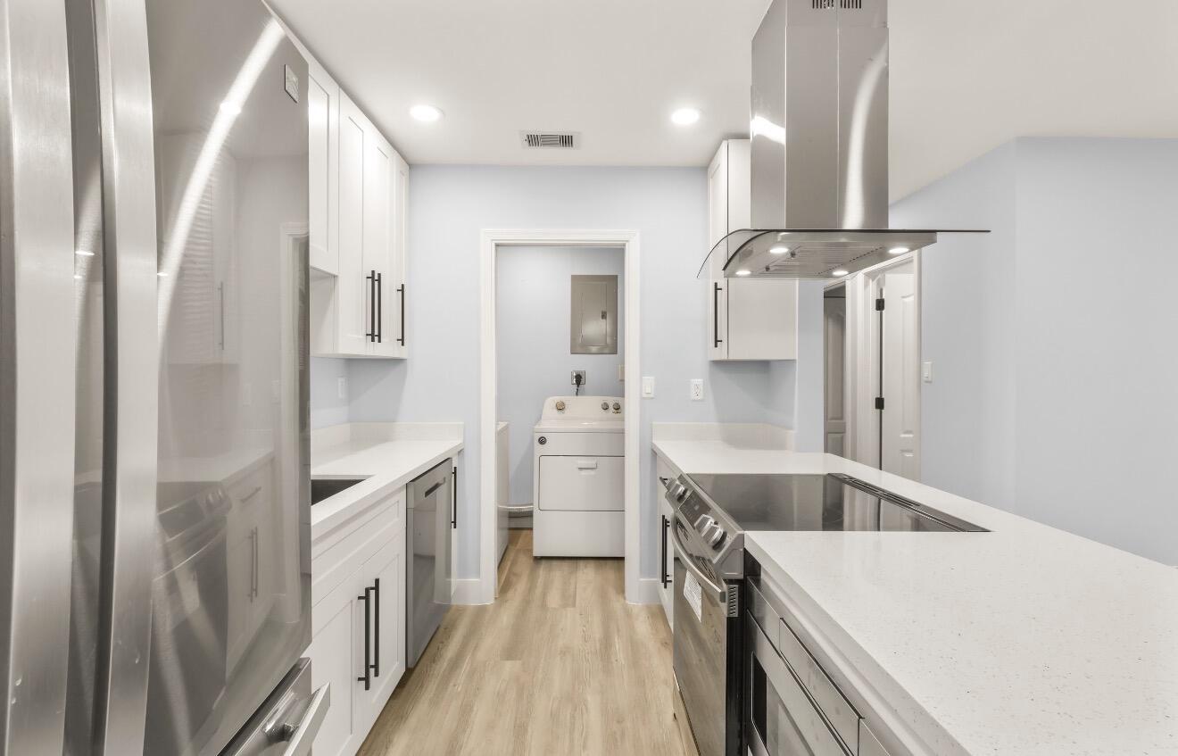 6717 Northwest 60th Street Tamarac, FL 33321 - Photo 3 of 26 a kitchen with a refrigerator sink and cabinets