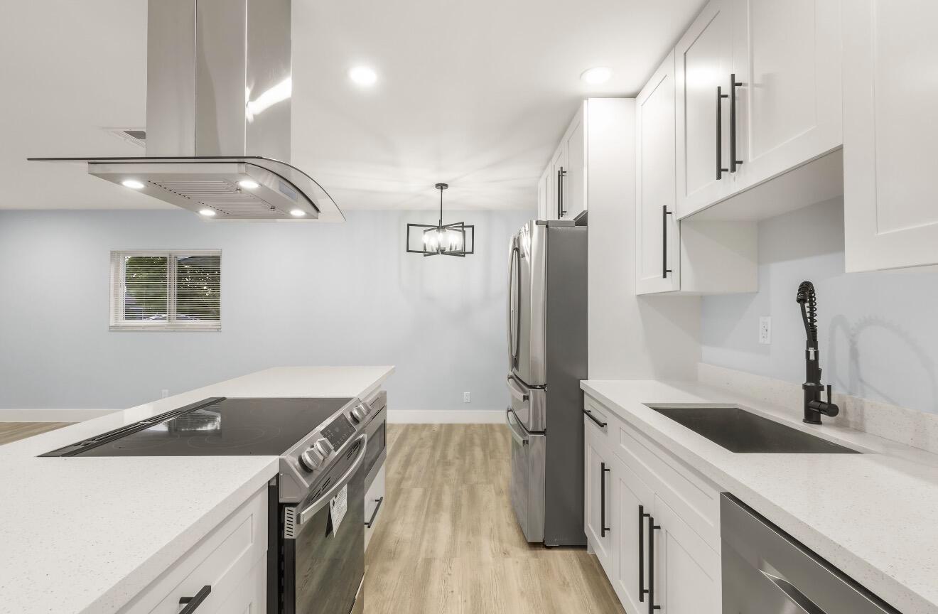 6717 Northwest 60th Street Tamarac, FL 33321 - Photo 4 of 26 a kitchen that has a sink a stove and a refrigerator
