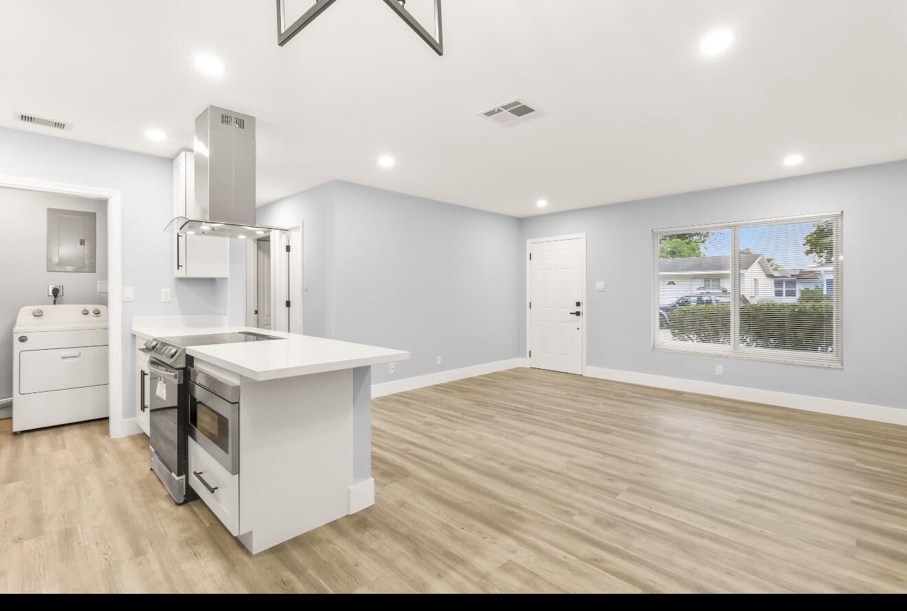 6717 Northwest 60th Street Tamarac, FL 33321 - Photo 7 of 26 a kitchen with a stove and a sink