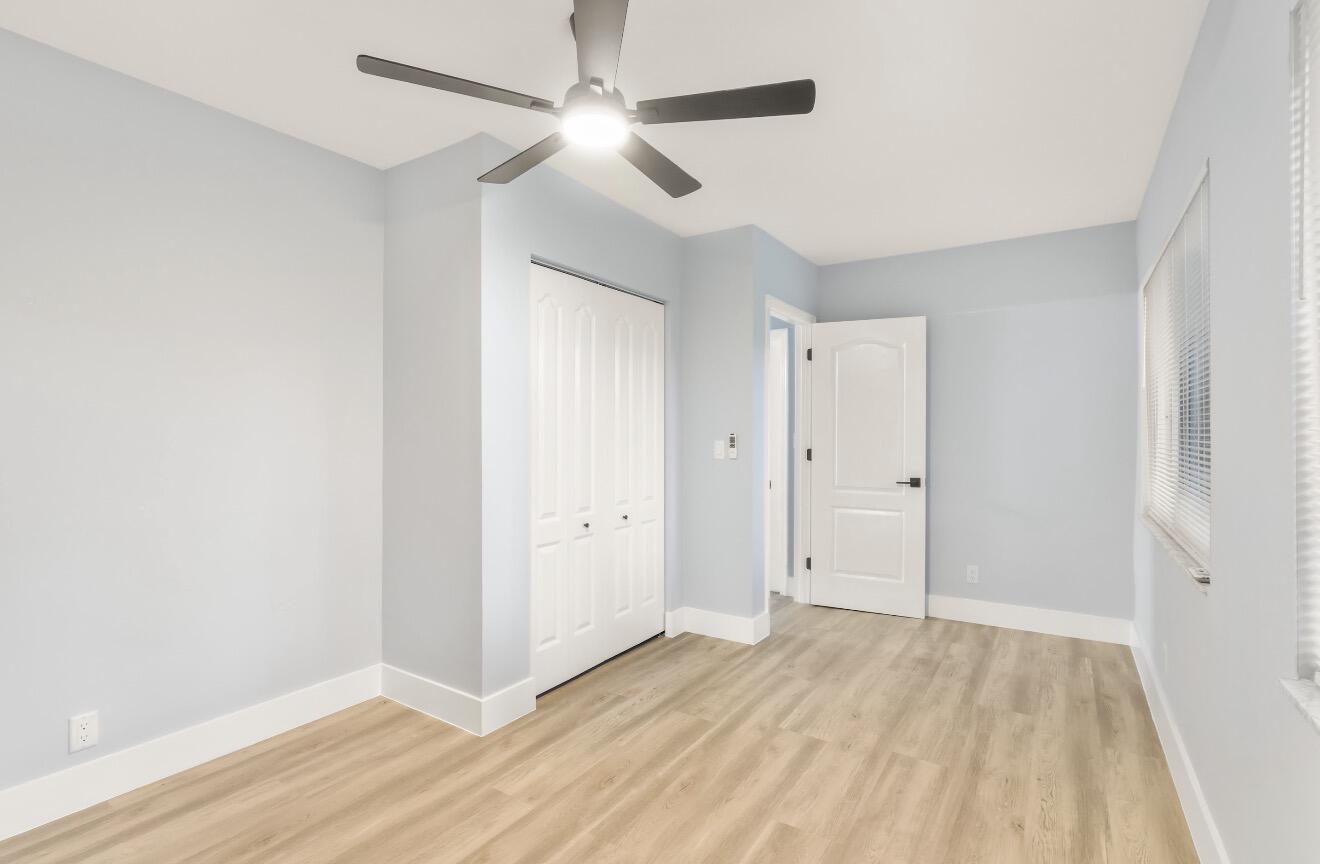 6717 Northwest 60th Street Tamarac, FL 33321 - Photo 9 of 26 wooden floor in an empty room with a window