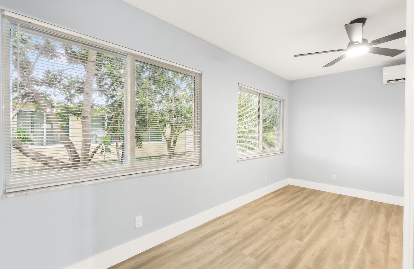 6717 Northwest 60th Street Tamarac, FL 33321 - Photo 10 of 26 a view of empty room with wooden floor and fan