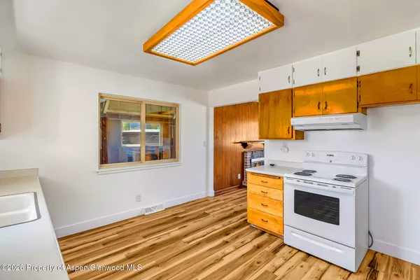 a kitchen with a sink a stove and cabinets