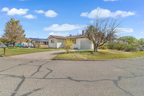 a view of a house with a yard and a garage