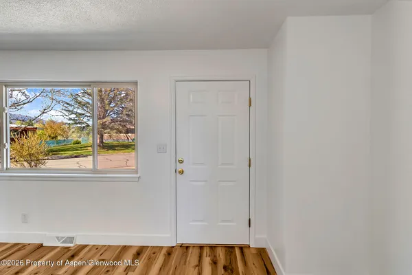 wooden floor fireplace and windows in a room