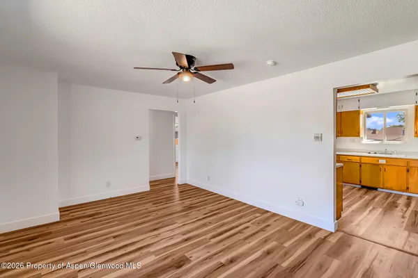 a view of a room with wooden floor and window