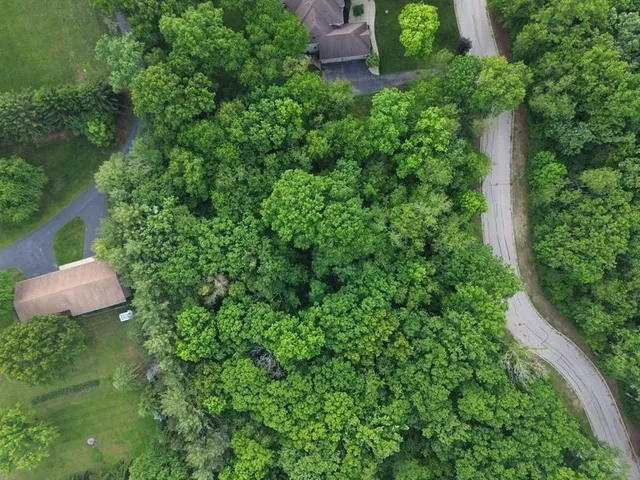 an aerial view of a house with a yard and outdoor seating