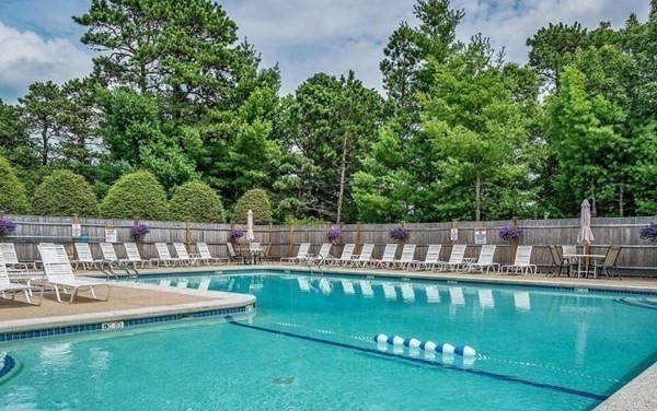 105 Shellback Way, Unit 105 Mashpee, MA 02649 - Photo 19 of 26 a view of a swimming pool with a garden