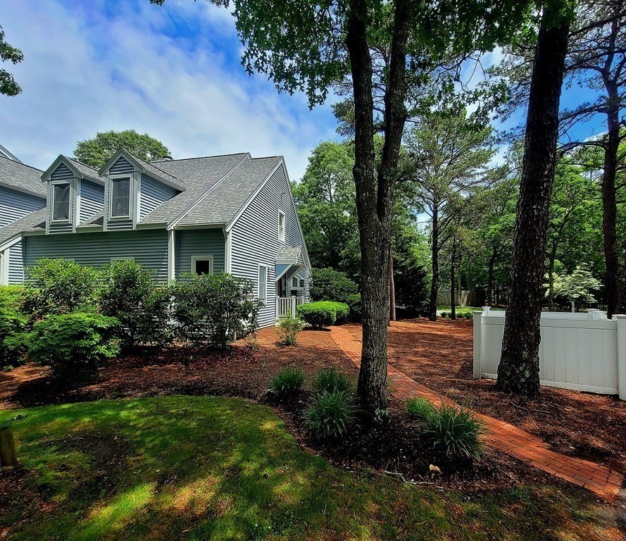 105 Shellback Way, Unit 105 Mashpee, MA 02649 - Photo 2 of 26 a front view of a house with a yard