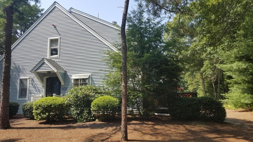 105 Shellback Way, Unit 105 Mashpee, MA 02649 - Photo 3 of 26 a view of a house with a yard