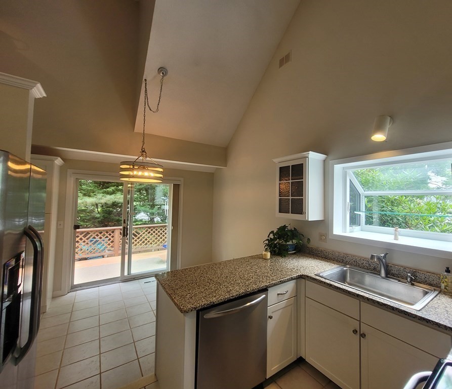 105 Shellback Way, Unit 105 Mashpee, MA 02649 - Photo 6 of 26 a kitchen with a sink and large window
