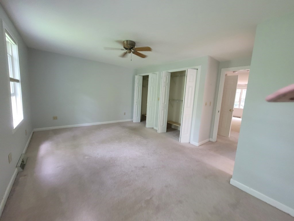 105 Shellback Way, Unit 105 Mashpee, MA 02649 - Photo 9 of 26 a view of a big room with windows and chandelier fan