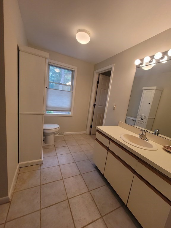 105 Shellback Way, Unit 105 Mashpee, MA 02649 - Photo 10 of 26 a bathroom with a sink a toilet and a mirror