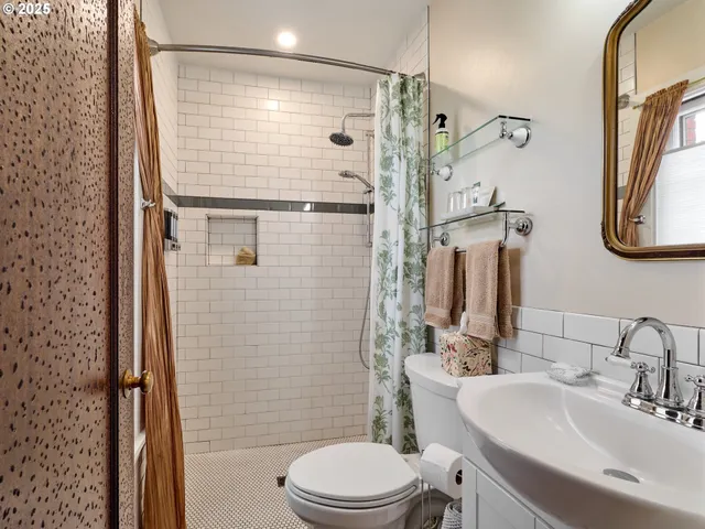 a view of a bathroom with a sink a mirror and a bathtub