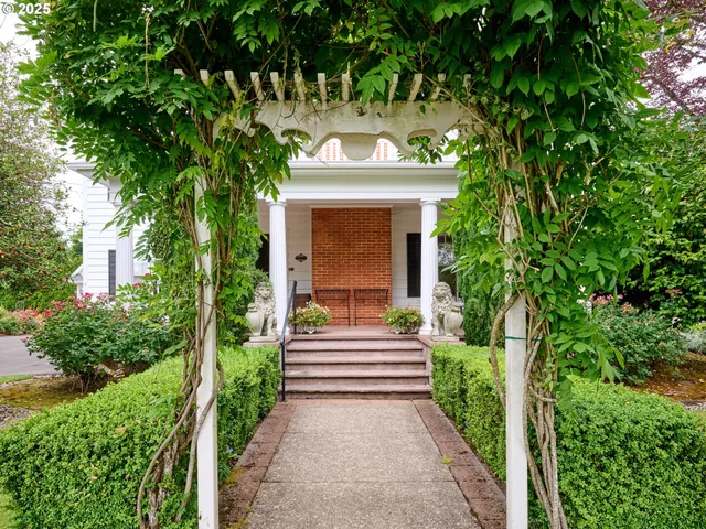 a front view of a house with a garden