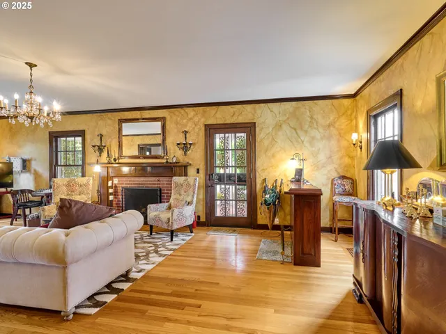 a living room with furniture a dining table and large windows