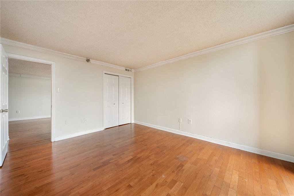 375 Ralph McGill Boulevard Northeast, Unit 1402 Atlanta, GA 30312 - Photo 11 of 17 a view of an empty room and wooden floor