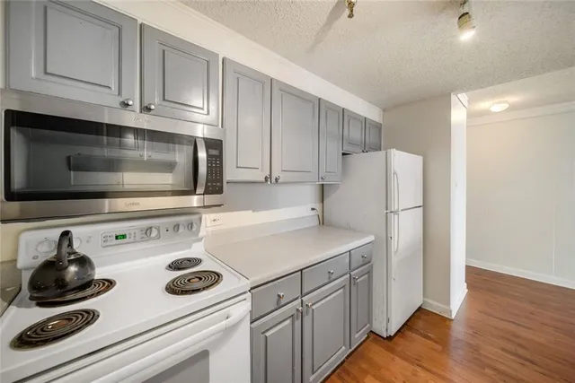 a kitchen with appliances a sink and cabinets