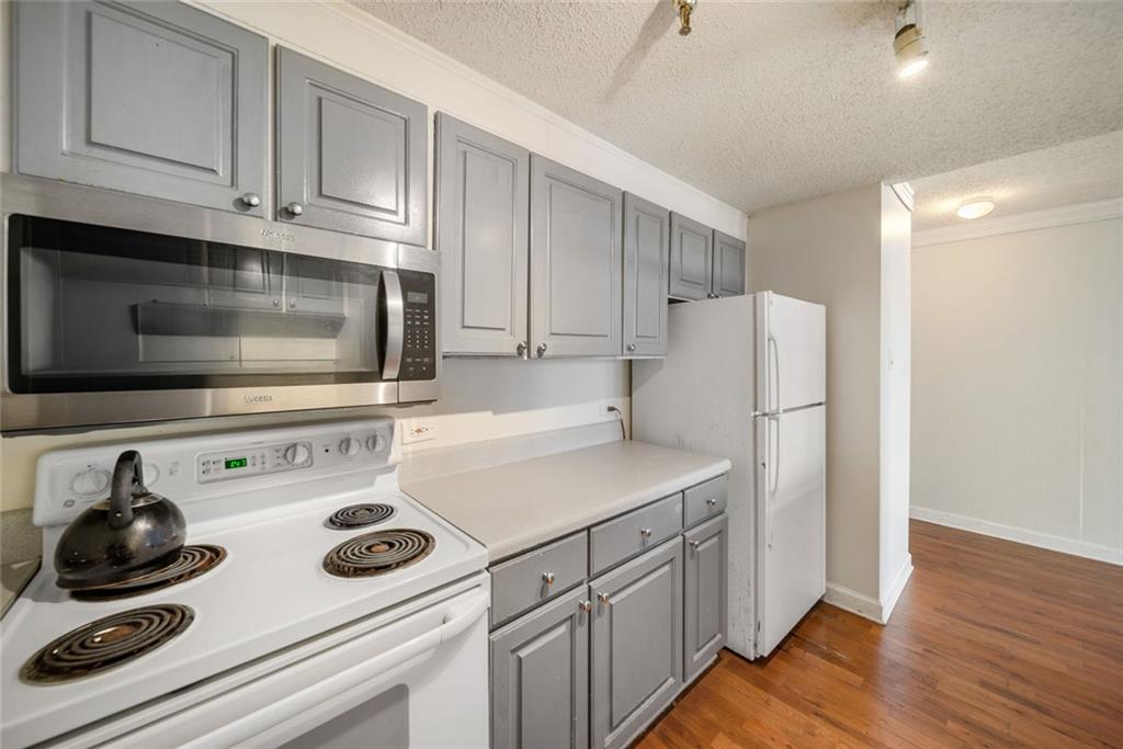 375 Ralph McGill Boulevard Northeast, Unit 1402 Atlanta, GA 30312 - Photo 13 of 17 a kitchen with appliances a sink and cabinets