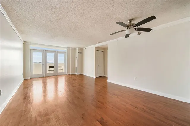 a view of a livingroom with a hardwood floor and a ceiling fan