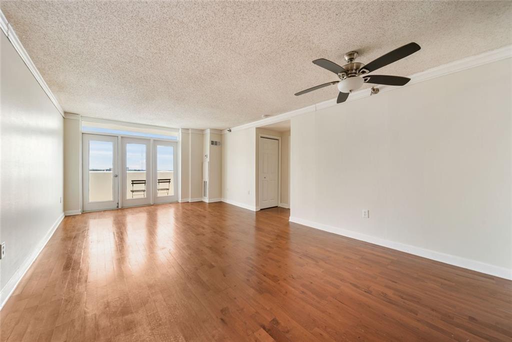 375 Ralph McGill Boulevard Northeast, Unit 1402 Atlanta, GA 30312 - Photo 5 of 17 a view of a livingroom with a hardwood floor and a ceiling fan