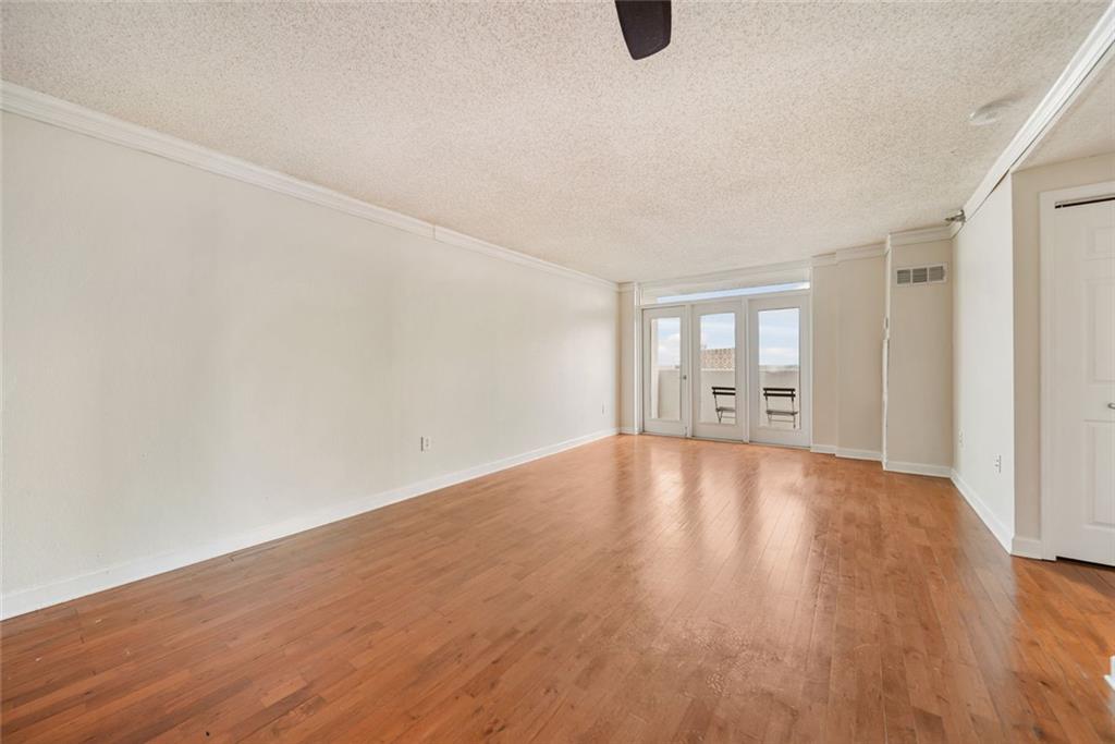 375 Ralph McGill Boulevard Northeast, Unit 1402 Atlanta, GA 30312 - Photo 7 of 17 wooden floor in an empty room with a window