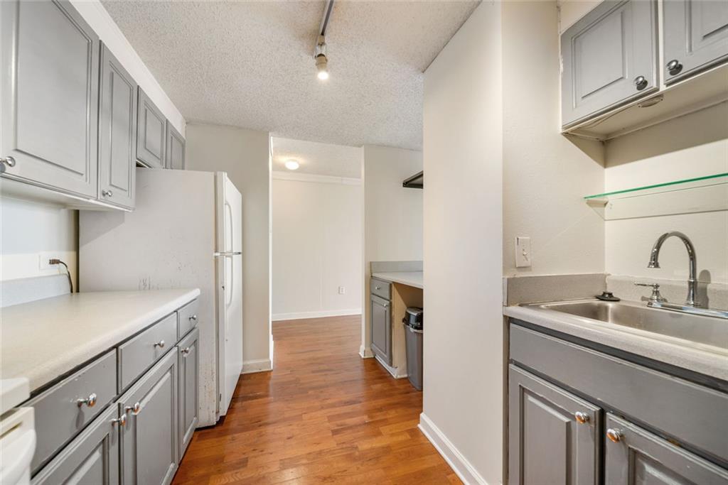 375 Ralph McGill Boulevard Northeast, Unit 1402 Atlanta, GA 30312 - Photo 8 of 17 a kitchen with a sink and a refrigerator