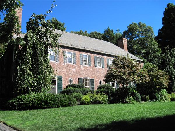 a aerial view of a house next to a yard