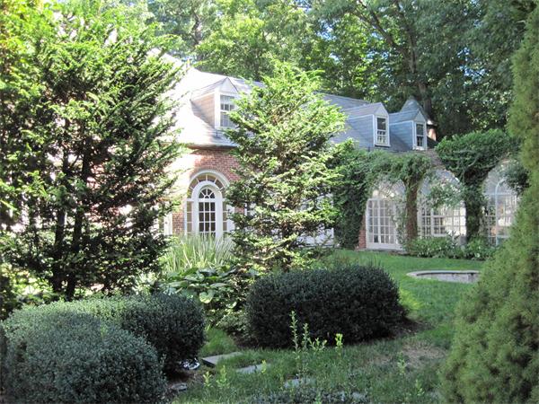 90 Sargent Road Brookline, MA 02445 - Photo 7 of 9 a front view of a house with a yard and tree s