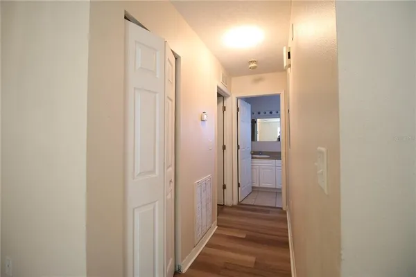a view of a hallway with a wooden cabinets