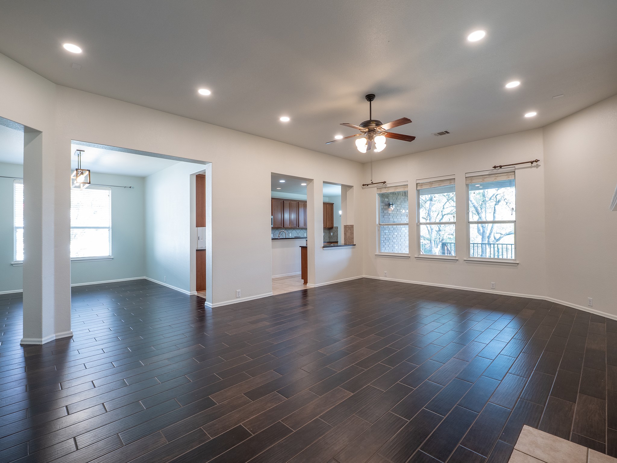 572 Big Meadow Road Austin, TX 78737 - Photo 31 of 32 An open floorplan seamlessly connects spaces, featuring rich wood-look flooring and ample natural light.