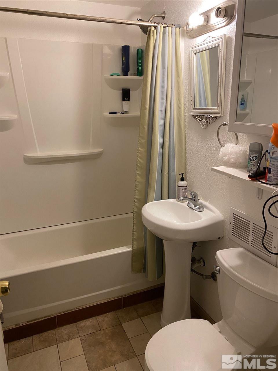 1885 Wilder Street Reno, NV 89512 - Photo 19 of 19 a bathroom with a sink a toilet and shower