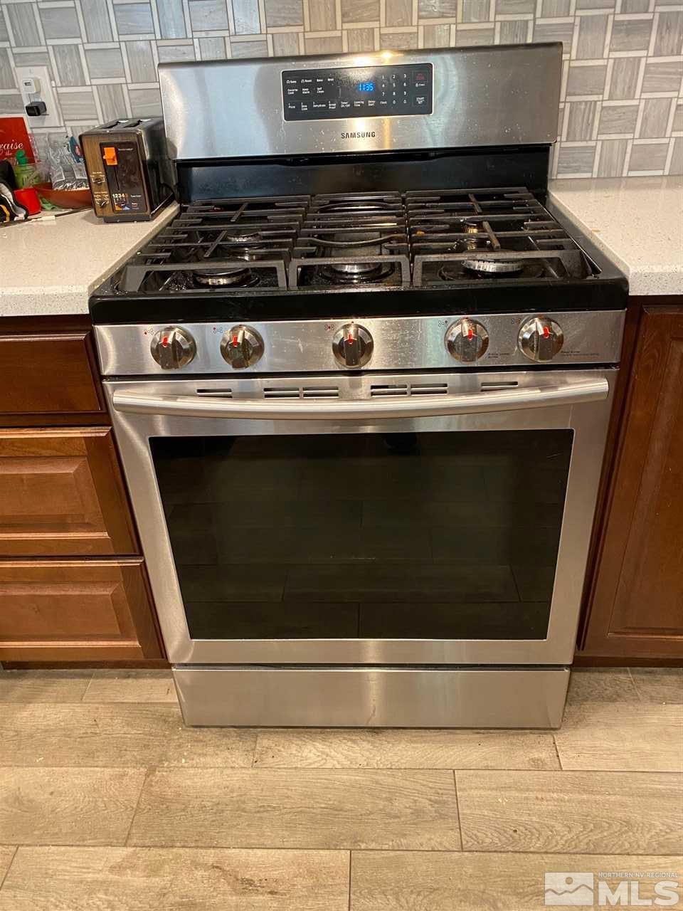 1885 Wilder Street Reno, NV 89512 - Photo 8 of 19 a stove top oven sitting inside of a kitchen