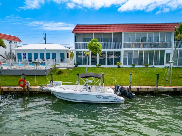a view of a house with swimming pool and a yard