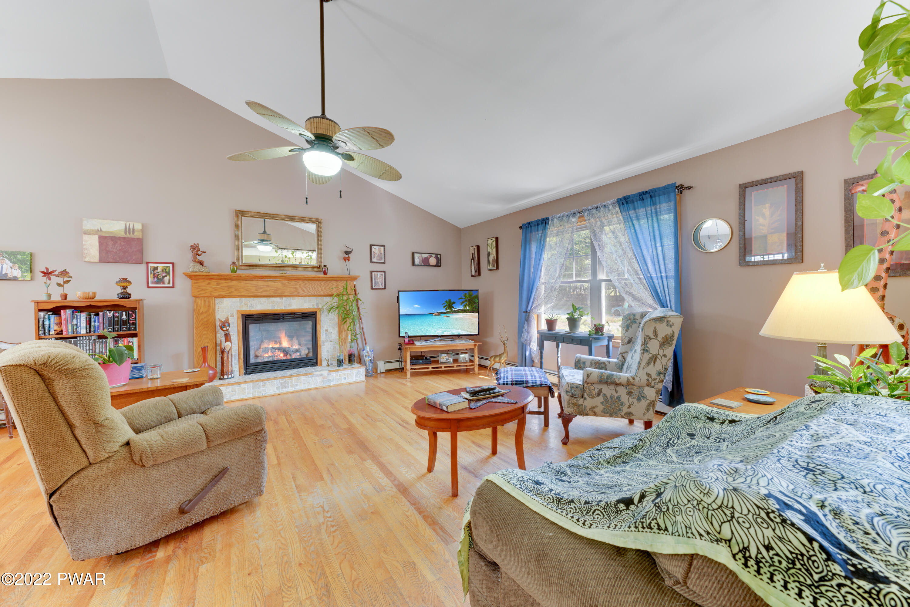 114 Lancaster Road Milford, PA 18337 - Photo 17 of 42 a living room with furniture a fireplace and a flat screen tv