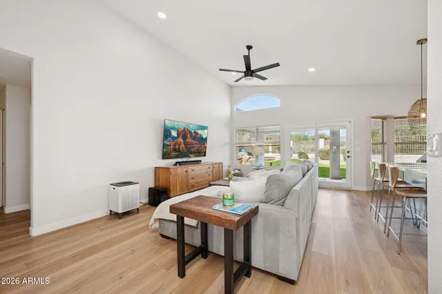 a living room with furniture and a wooden floor