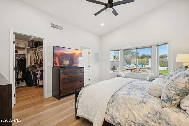 a bedroom with a bed and a flat screen tv